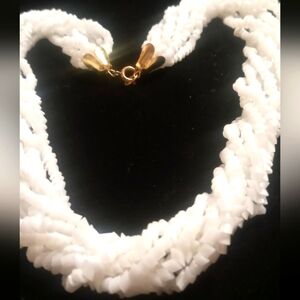 Vintage white 8 strand 18 inches long shell necklace.